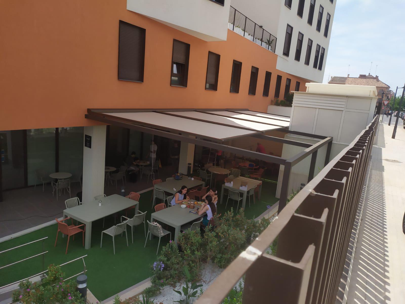 Instalación de sistema de toldo veranda sobre estructura metálica en residencia de estudiantes de Valencia por Toldos Valencia.